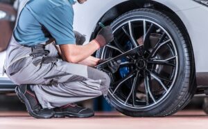 auto mechanic inspecting car tires