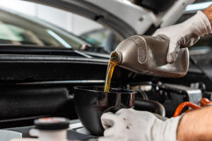 auto technician performing an oil change in tucson az