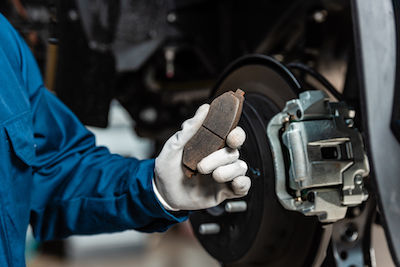 auto mechanic hold brake pads