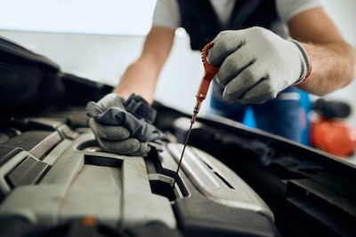 auto mechanic performing an oil change