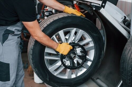 Work in progress. Man in uniform is in the auto service. Work in progress. Man in uniform is in the auto service.